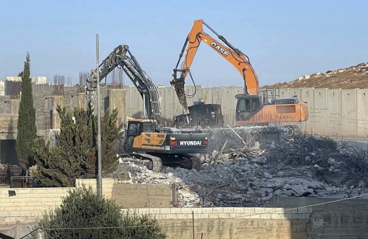 The occupation forces a Jerusalemite to demolish two floors of his home